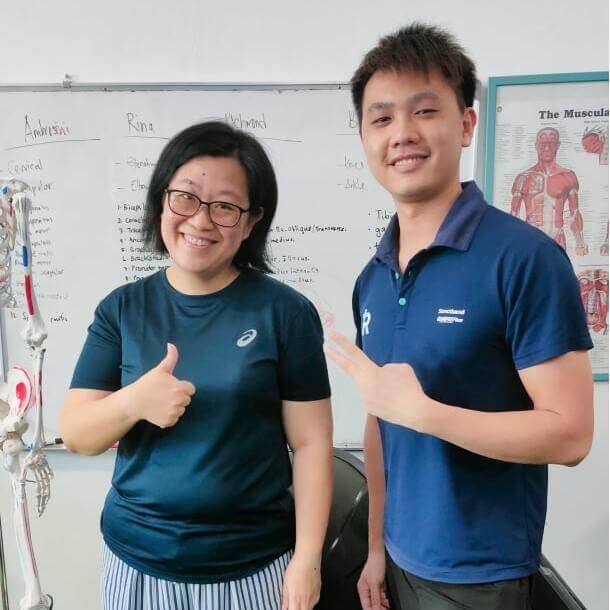 Jaffery and his patient with thumbs up in front of a whiteboard with handwritten notes.